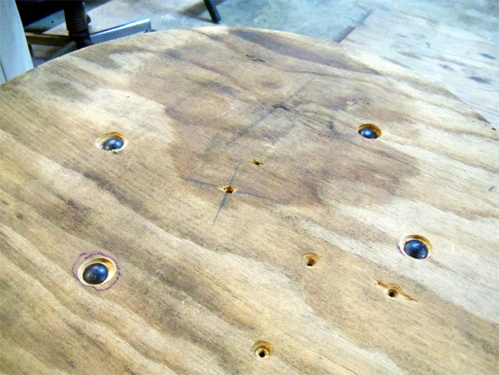 The 30-inch plywood circle, with countersunk support bolts visible.