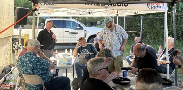 Bud Williamson and Andy Gladding speak at the SBE 15 summer barbecue.