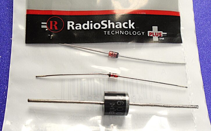 Solid-state diodes for all seasons and reasons. From top: a 12 volt Radio Shack zener sitting inside its original packaging, a classic 1N914 and a 5 amp 1000 volt rectifier.