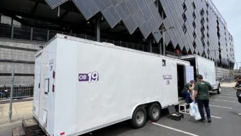 An outside broadcast vehicle deployed at Lincoln Financial Field in Philadelphia for the FIFA World Cup 2026. The setup integrates local RTS intercom systems with AEQ's Xpeak communications network to link production teams across multiple countries.