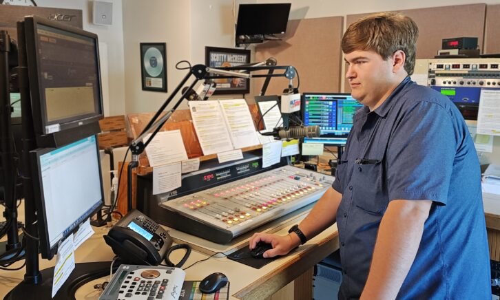Jake Bleck at the controls of an Emergency Alert System Required Weekly Test.