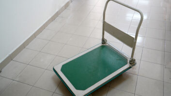 Green base trolley with white handle, selective focus.
