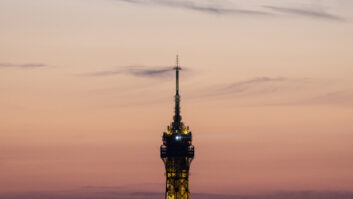 This photograph shows a view of top of The Eiffel Tower with antennas as the sun sets in Paris on July 14, 2024. (Photo by Olympia DE MAISMONT / AFP) (Photo by OLYMPIA DE MAISMONT/AFP via Getty Images)