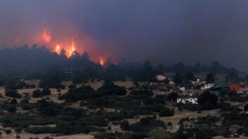 The Aspen Acres fire burns behind homes on July 3, 2026 in Rye, Colo.