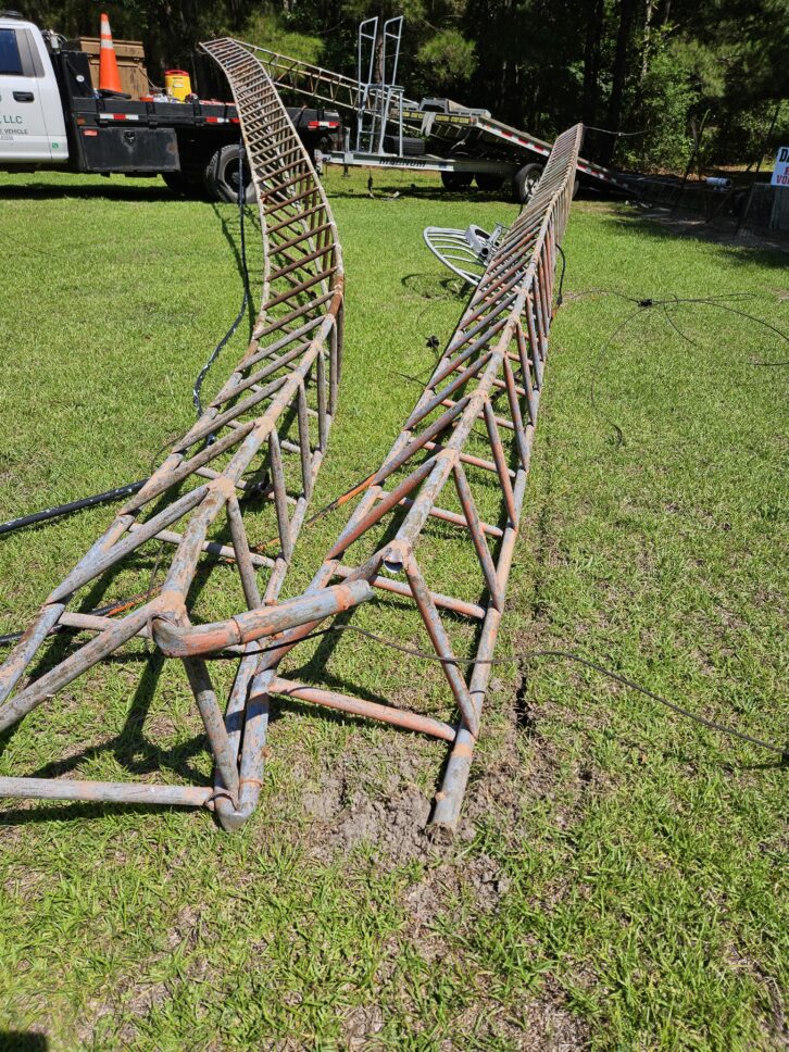 Severed guy wires caused 1300 WLNC(AM)'s original 1962 radio tower to collapse into three twisted sections, taking the station off the air on July 16.