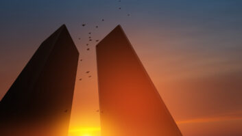 The sun is seen between the two towers of the former World Trade Center in New York City.