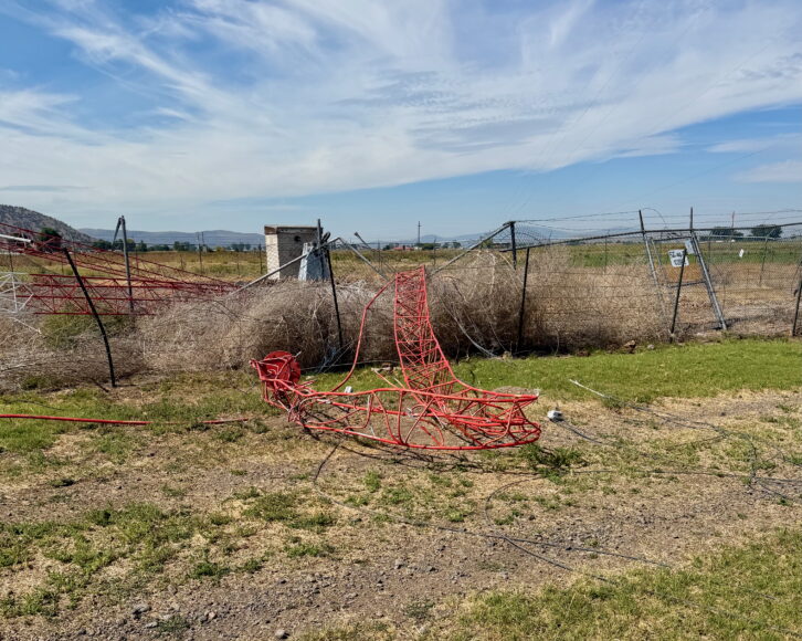 Twisted steel and fencing mark the site where KLAD(AM)’s Tower #3 collapsed after being struck by a crop-duster aircraft in Klamath Falls, Ore., on Aug. 20. Credit: Rob Siems