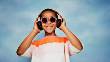 Happy boy listening to music through headphones