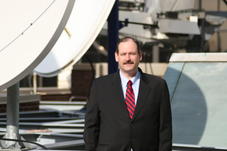 Conrad Trautmann in a contemporary photo taken on the roof of the CBS Broadcast Center next to uplink dishes.
