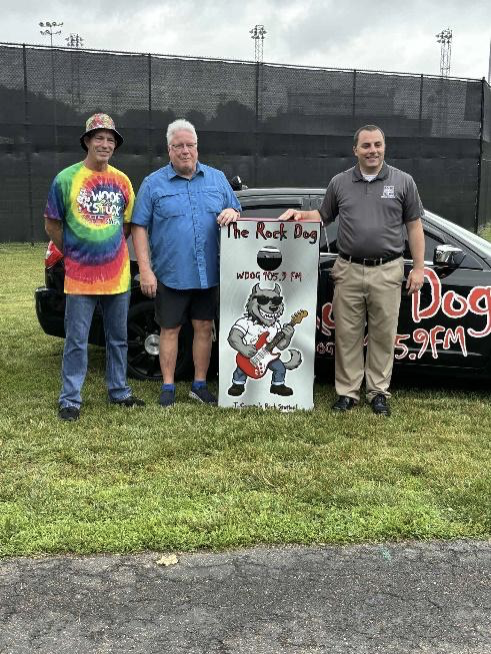 WDOG(LP) general manager and "Unleashed" morning host Steve Slentz alongside New Philadelphia Mayor Joel Day and Dover Mayor Shane Gunnoe, getting ready to give away a custom Rock Dog cornhole game in front of the station’s "Hot Rod Lincoln."