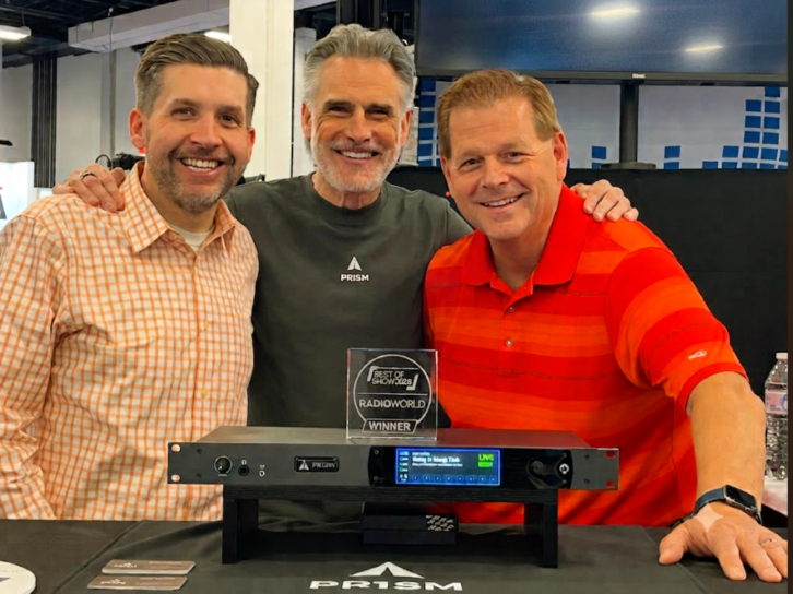 Learfield’s Ben Blevins, left, and Randy Williams, right, are shown with Adrian Berkovits of Adventure 33.