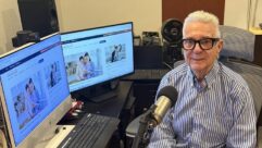 Larry Magid sits in a studio in front of computer screens