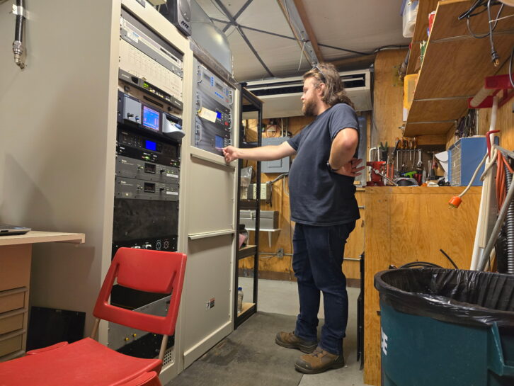 Neace working to bring a backup transmitter online following a late-night storm.