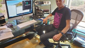 Richard Factor sits at his office desk and computer screen