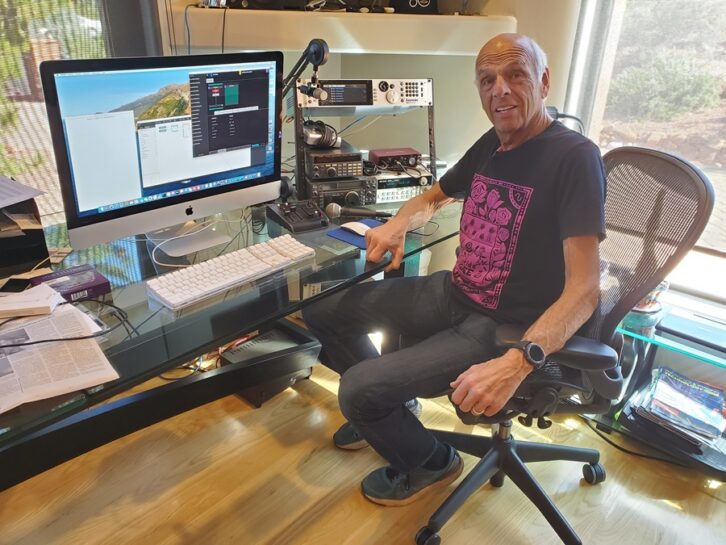Richard Factor sits at his office desk and computer screen