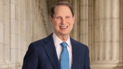 Headshot of Senator Ron Wyden standing in front of classical columns