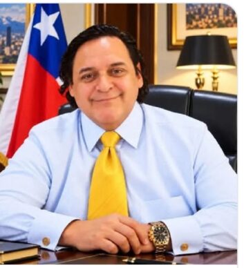 Basay Roberts sits at a desk in front of a Chilean flag