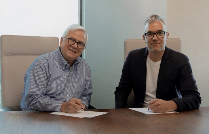 K-LOVE CEO Tom Stultz and TWR President/CEO Andy Schick sit at a table