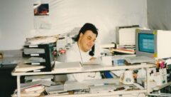 Don Winget is shown in an undated photo at a desk in a cluttered work area.