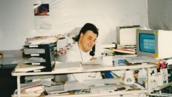 Don Winget is shown in an undated photo at a desk in a cluttered work area.
