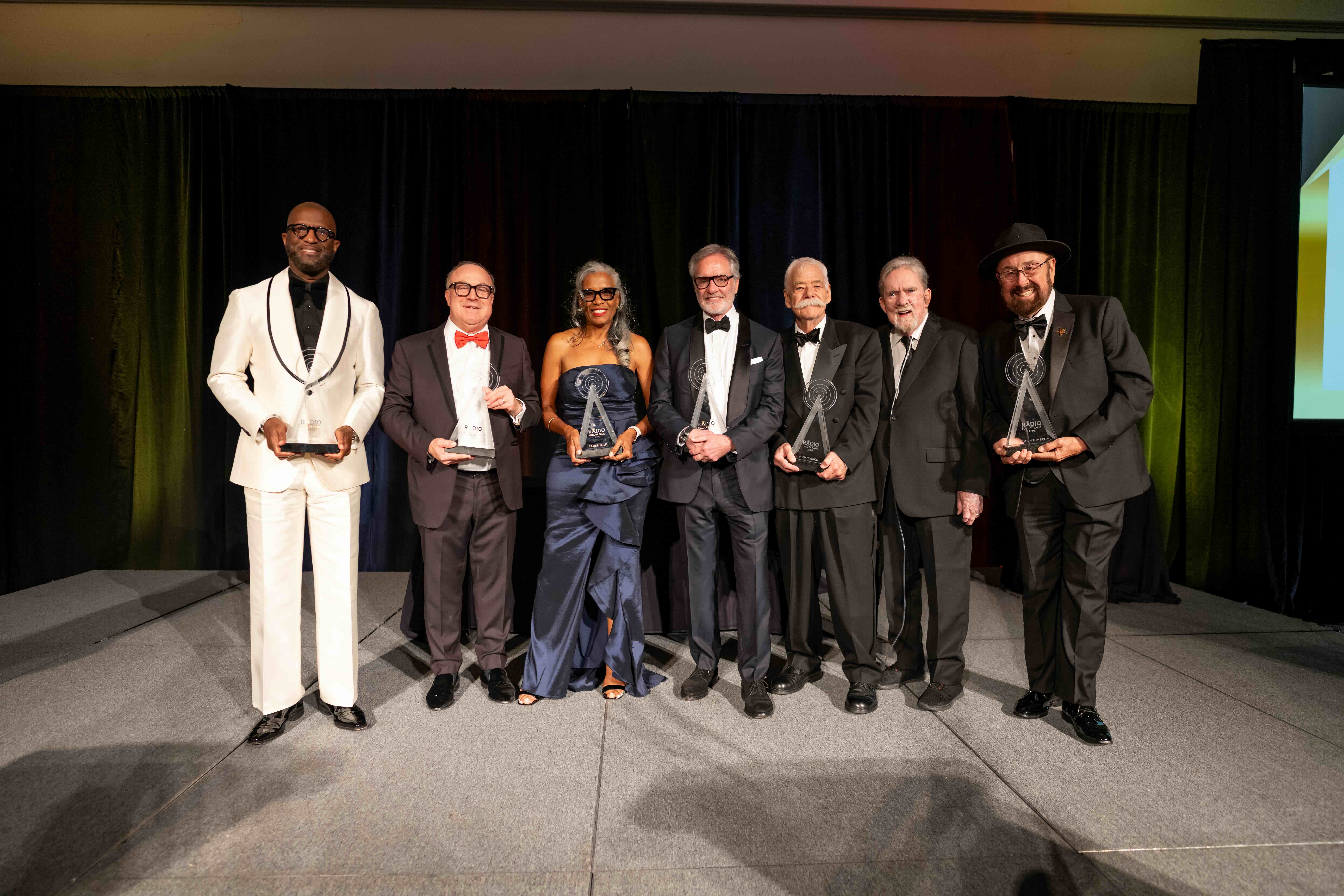 Left to right: Rickey Smiley, Dennis Green, Helen Little, Bob Pittman, Fred Winston, Charlie Van Dyke and Shotgun Tom Kelly. Not pictured in the group photo of inductees is Boomer Esiason.