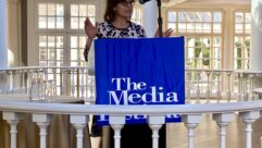 Commissioner Anna Gomez speaking at a podium at the Media Institute